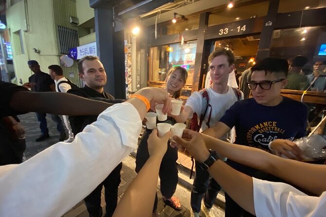 3Hour Osaka Pub Crawl Bar Hopping Nightlife Guided Tour in Namba - Stop two: Kanemasa Liquor Store and standing okonomiyaki