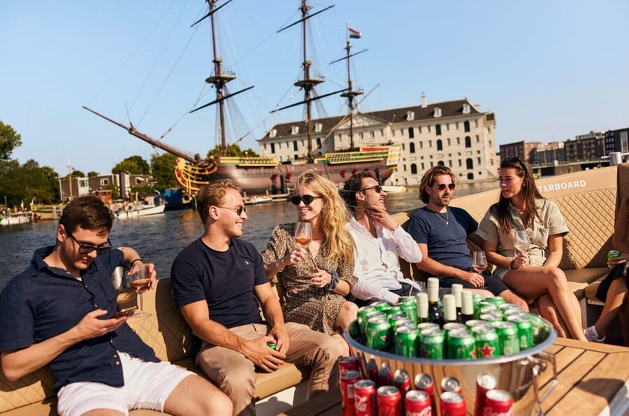 Amsterdam: German Guided Canal Cruise with on Board Bar - Saint Nicholas Basilica and the maritime side of Amsterdam