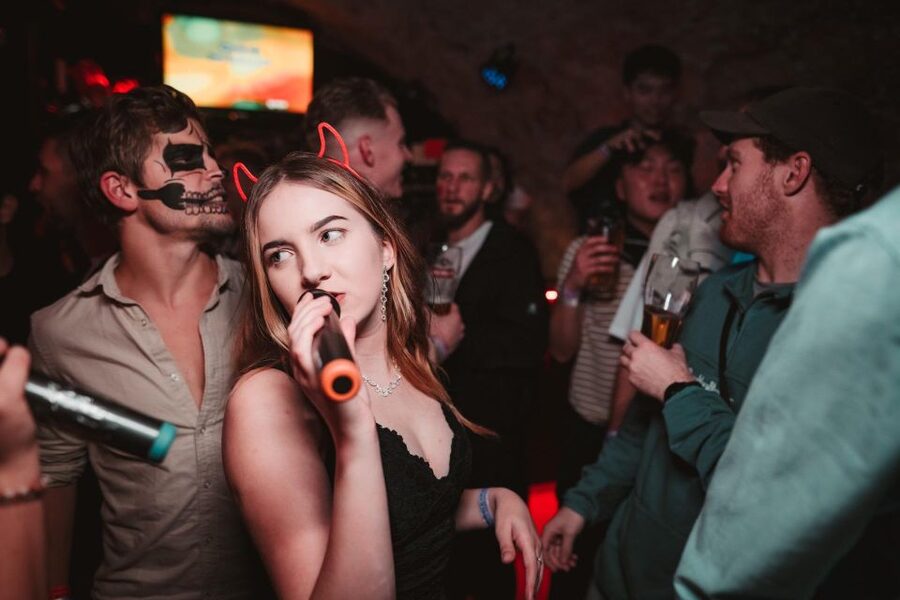Krakow: Pub Crawl with 1 Hour of Unlimited Alcoholic Drinks - A photographer records the night