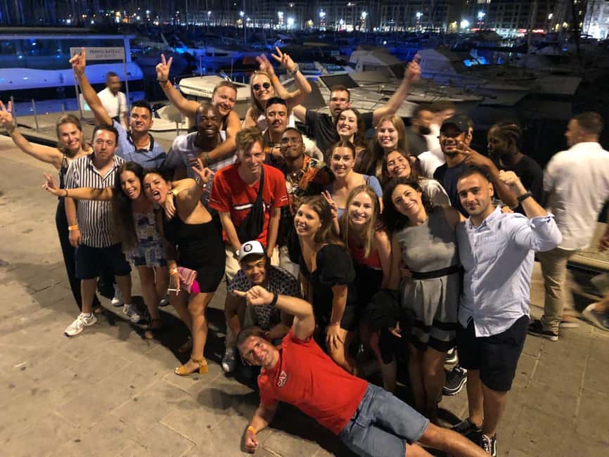 Marseille Pub Crawl: Explore by Night Meet, Mingle & Party - Walking through Marseille’s Old Port after dark