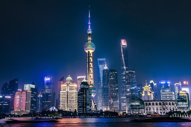 Shanghai Authentic Dinner and Night River Cruise with Rooftop Bar Hopping Option - Eating soup dumplings and local Shanghainese dishes