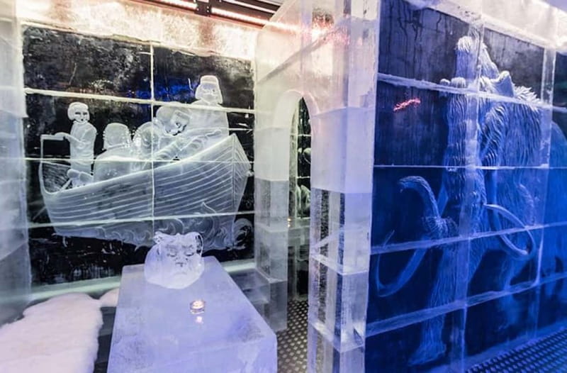Tromsø: Magic Ice Bar Entrance and Welcome Drink - Viking carvings and explorer sculptures